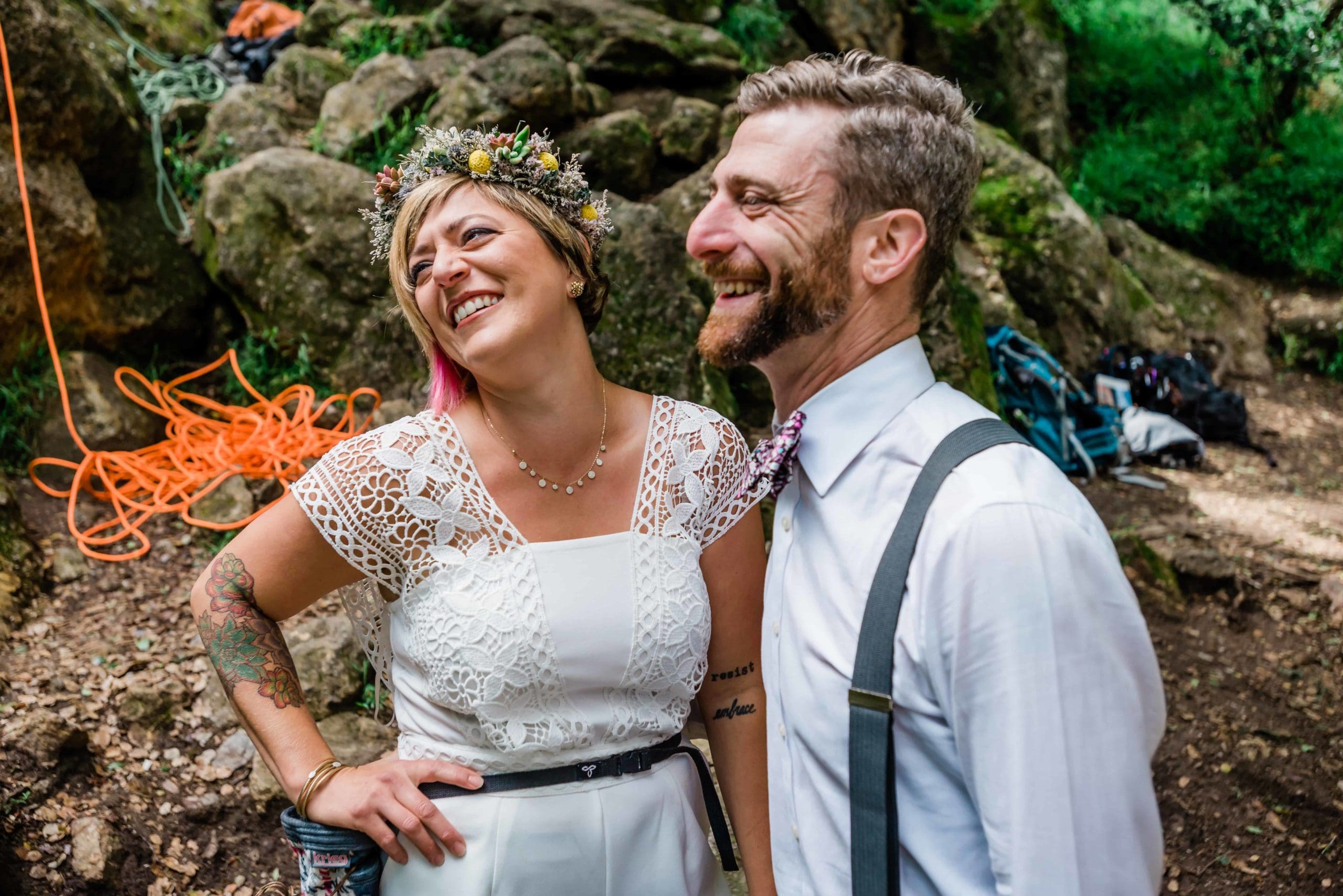 couple shares a laugh, looking off camera. 