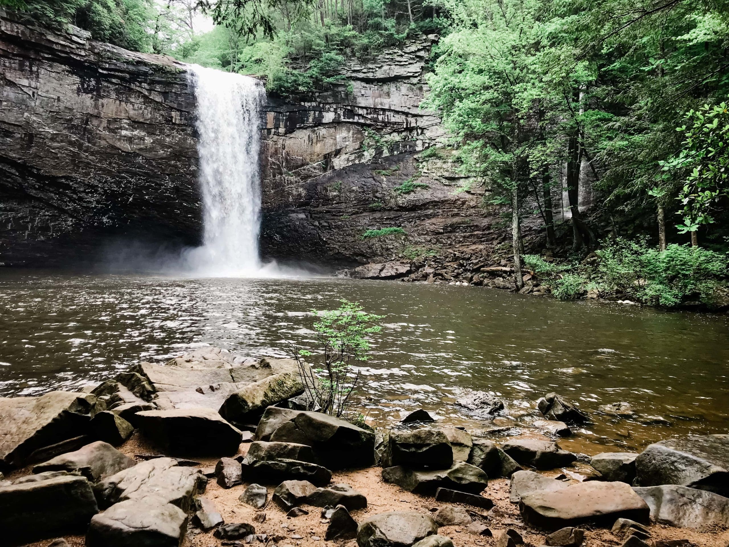 This picture is of a Tennessee waterfall location for elopements. It is taken from down below near the river.