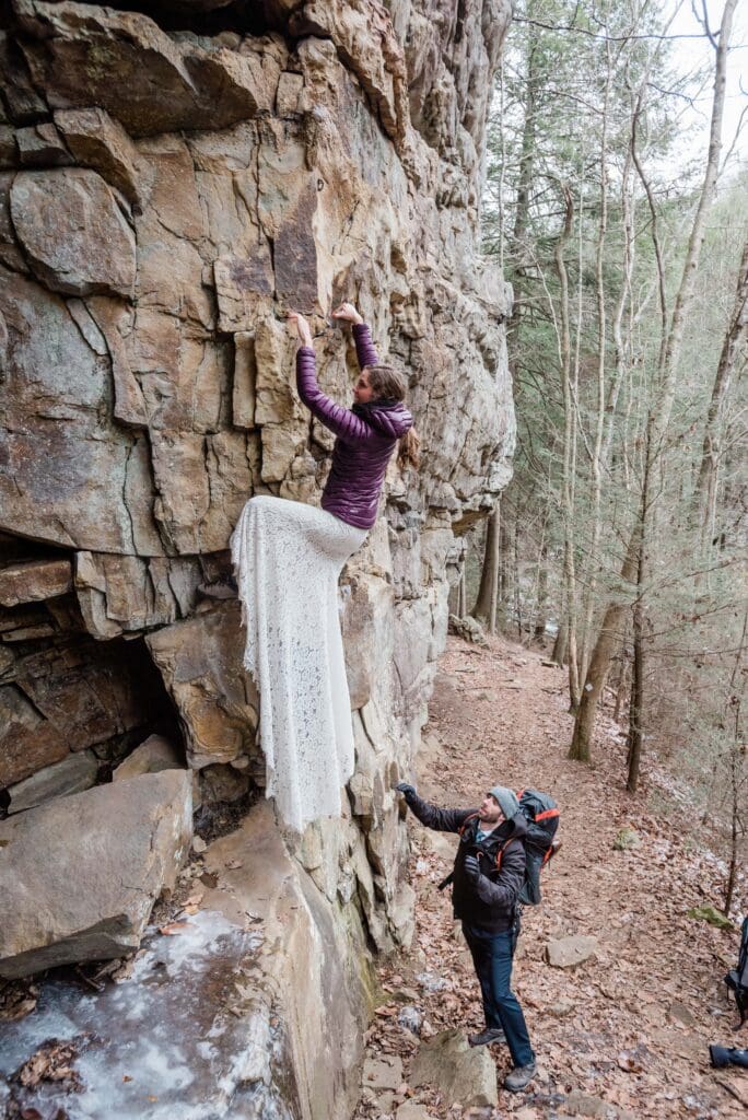 This is a picture of a bride rock climbing in her wedding dress during her Chattanooga elopement.