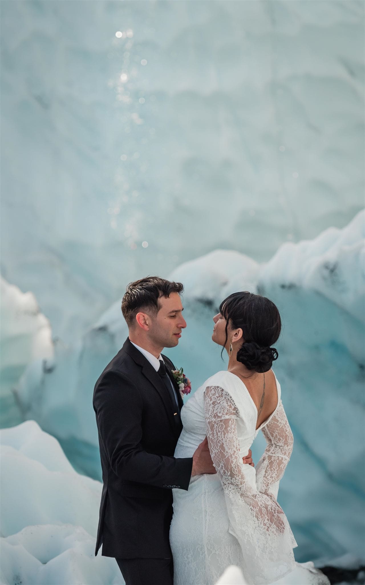 In this Alaska elopement, the bride and groom photographed in glacier cliffs.