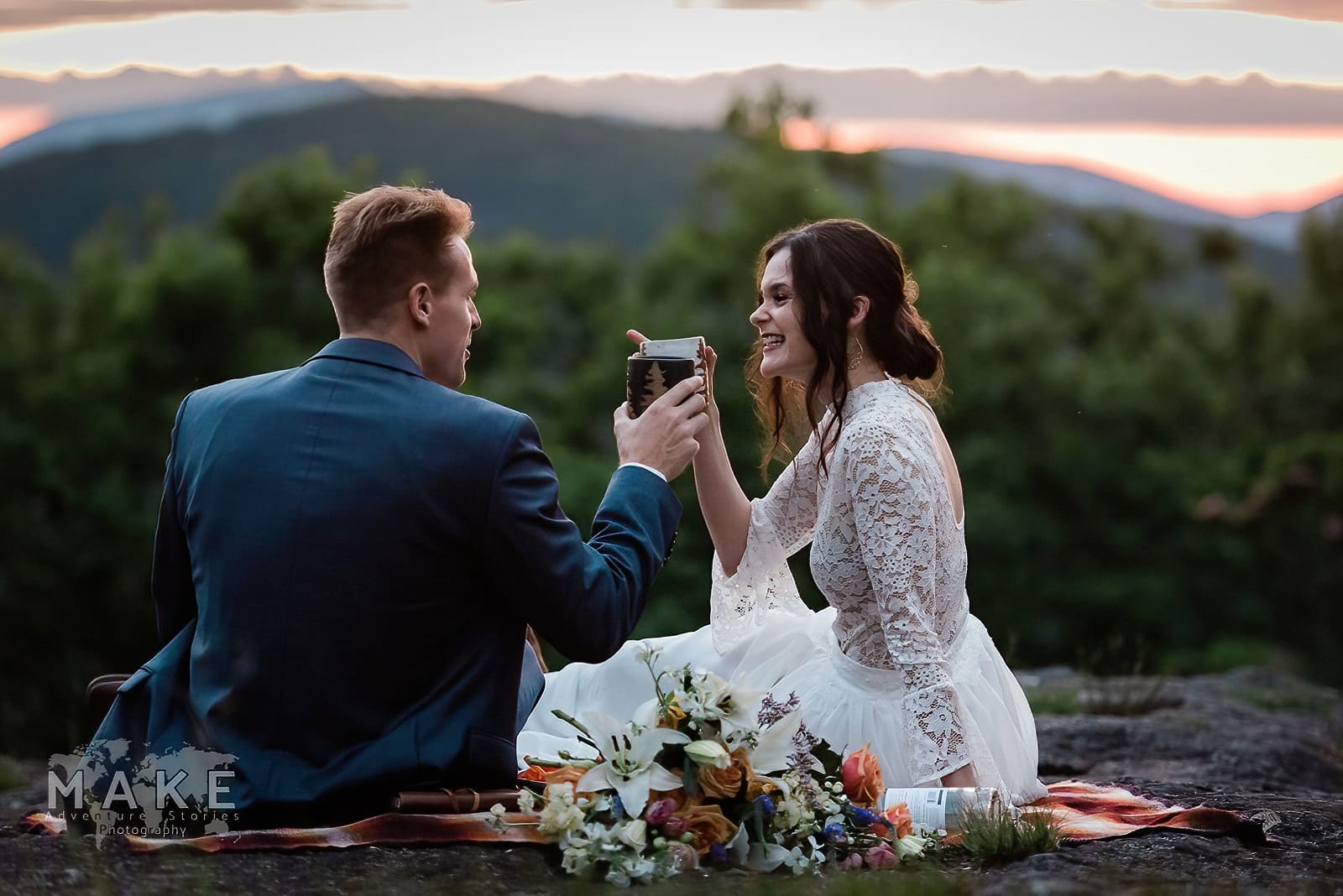 This is a picture of a bride and groom cheers-ing on a mountain after their elopement ceremony. This couple decided to elope in Georgia.