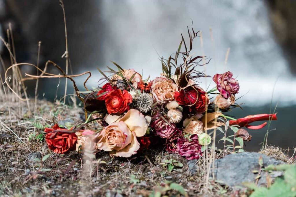 A earth-tone colored elopement wedding bouquet designed for a glacier elopement in Alaska