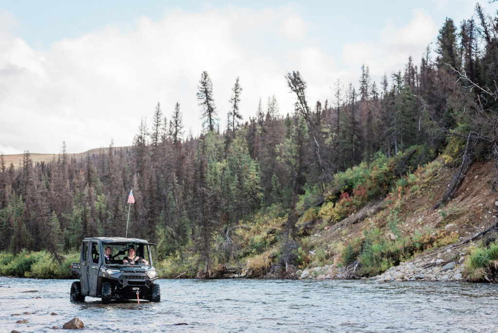 This is a picture of a bride and groom riding an ATV in Alaska